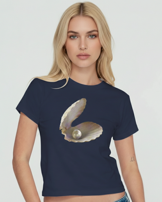 Woman wearing a navy blue t-shirt with an oyster and pearl graphic on a white background