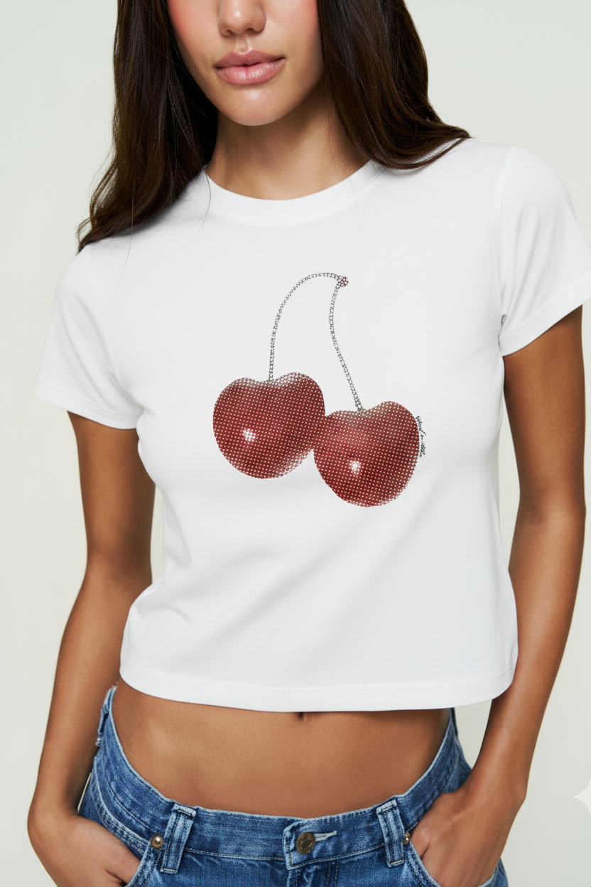 Person wearing a white t-shirt with red cherry design on a plain background