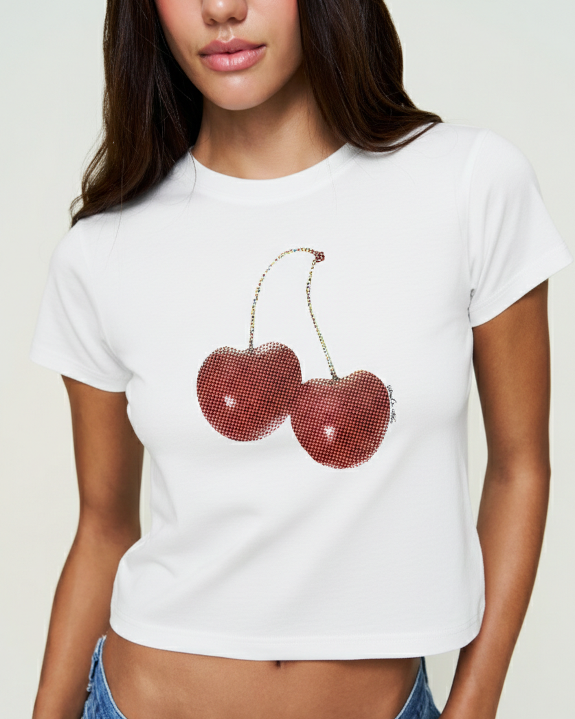 Person wearing a white t-shirt with red cherry design on a plain background