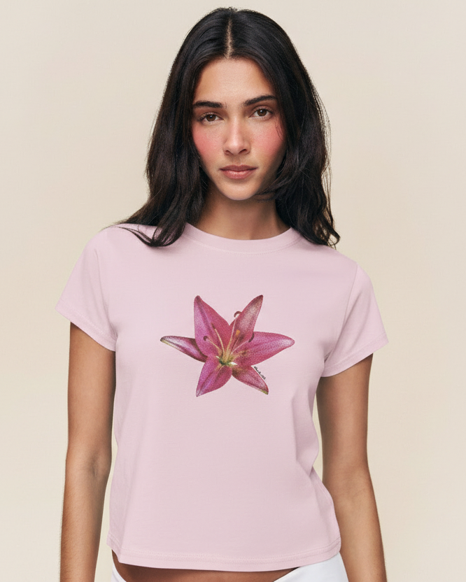 Woman wearing a pink t-shirt with a flower design on a beige background