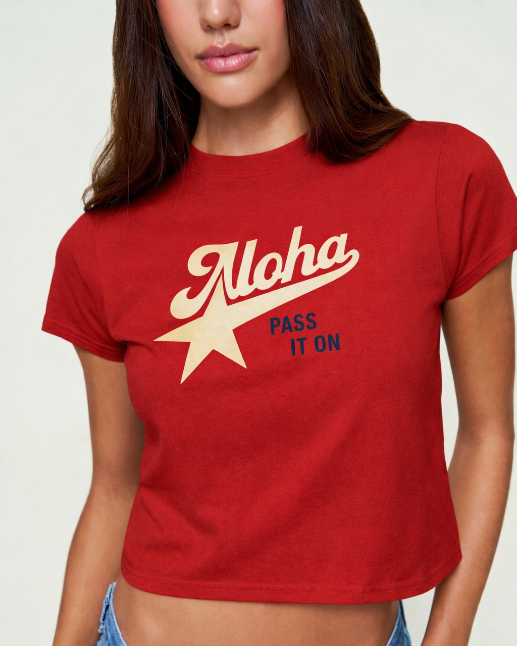 Person wearing a red t-shirt with 'Aloha Pass It On' design on a plain background