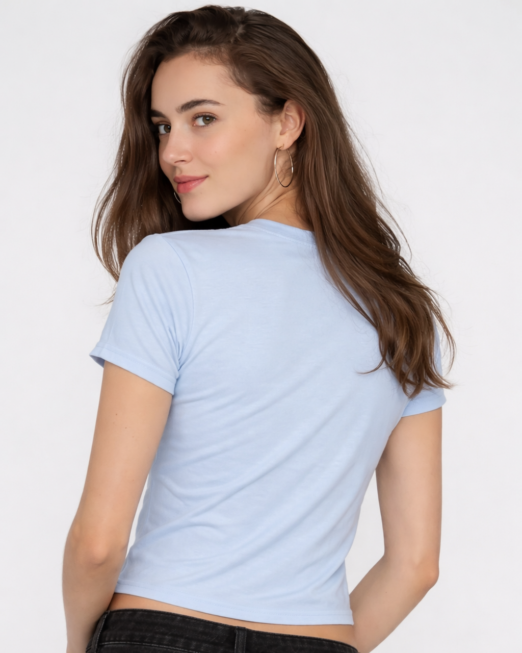 Woman wearing a light blue t-shirt and black pants against a white background