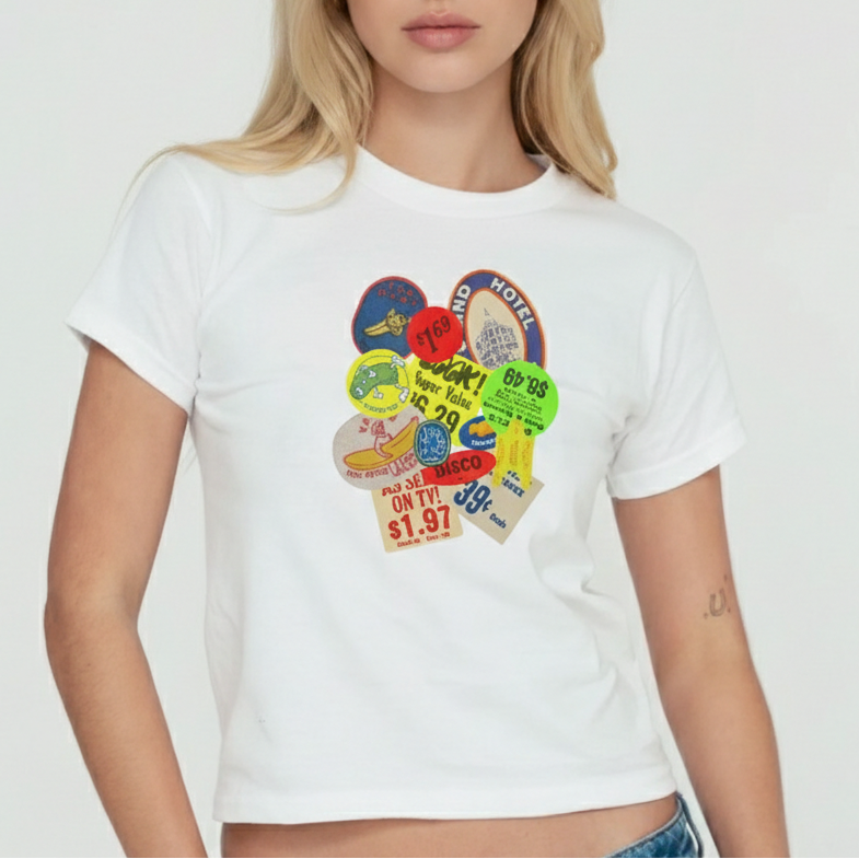 Woman wearing a white t-shirt with colorful graphic design on a plain background